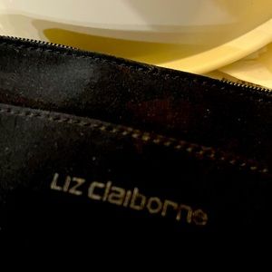 Liz Claiborne black material crossbody bag with 3 separate compartments.